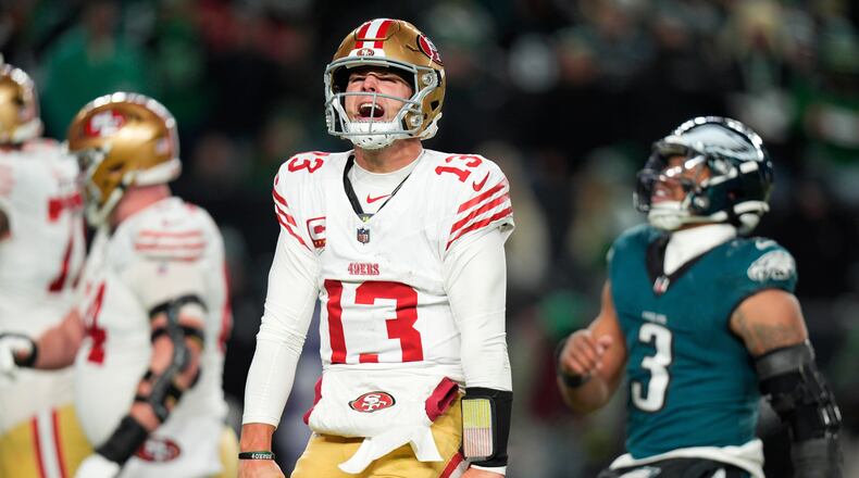 San Francisco 49ers quarterback Brock Purdy (13) reacts to a touchdown pass to 49ers running back Christian McCaffrey during the second half of an NFL wild-card playoff football game against the Philadelphia Eagles on Sunday, Jan. 11, 2026, in Philadelphia. (AP Photo/Chris Szagola)