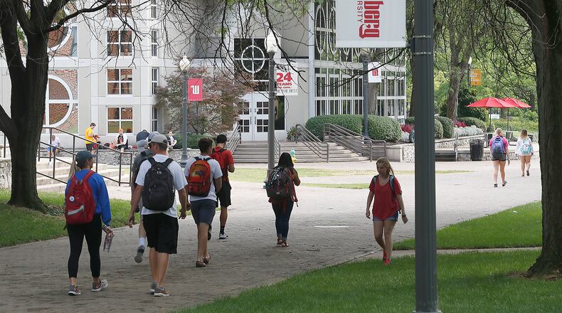 Students walk across campus at Wittenberg University Tuesday. Bill Lackey/Staff