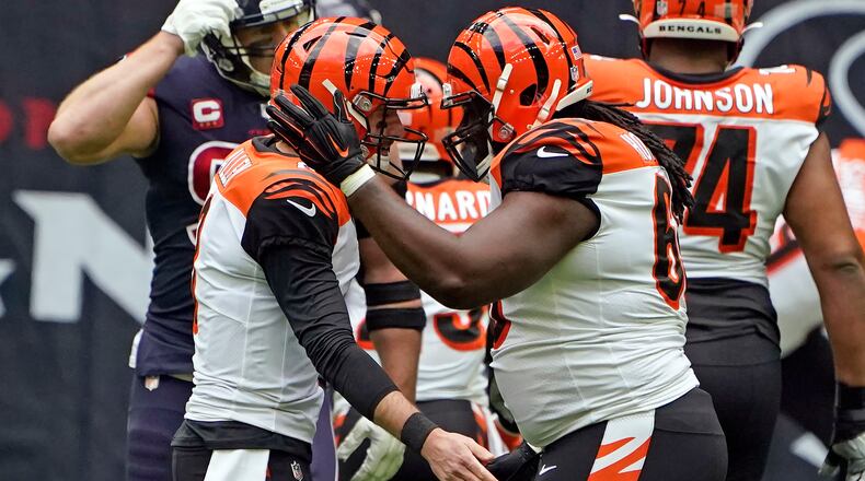 Cincinnati Bengals quarterback Brandon Allen, left, celebrates with center Trey Hopkins after throwing a touchdown pass against the Houston Texans during the first half of an NFL football game Sunday, Dec. 27, 2020, in Houston. (AP Photo/Eric Christian Smith)