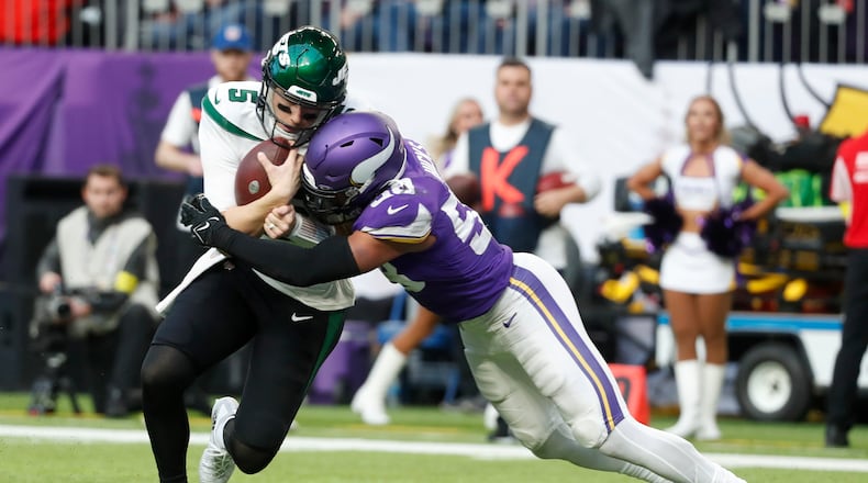 New York Jets quarterback Mike White (5) is tackled by Minnesota Vikings linebacker Jordan Hicks (58) during the second half of an NFL football game, Sunday, Dec. 4, 2022, in Minneapolis. (AP Photo/Bruce Kluckhohn)