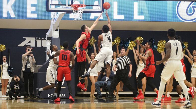 Dayton’s Ryan Mikesell defends a shot by George Washington’s Justin Williams on Wednesday, Jan. 9, 2019, at the Charles E. Smith Center in Washington, D.C. David Jablonski/Staff