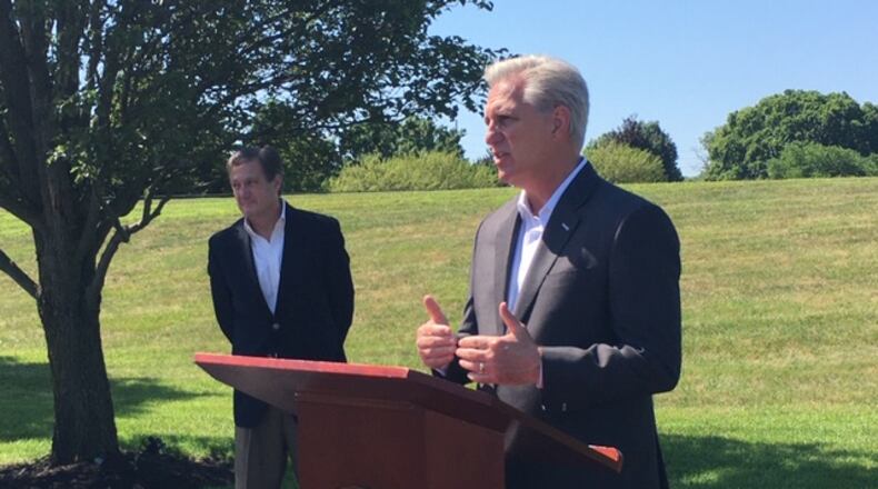 House Republican Leader Kevin McCarthy, R-California, at the podium outside Hope Hotel at Wright-Patterson Air Force Base Tuesday. U.S. Rep. Mike Turner, R-Dayton, stands to McCarthy’s right. THOMAS GNAU/STAFF