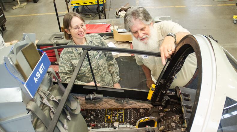 In a 2015 photo, Col. Elena M. Oberg, then the 88th Air Base Wing vice commander, views an aircraft at the National Museum of the U.S. Air Force Museum with Englewood resident and museum volunteer Larry Youngblood. FILE