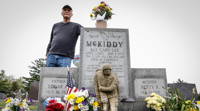 Jim Skaggs stands near the grave of Sgt. Gary McKiddy at Highland Memorial Cemetery in Miamisburg. Both men served together in Vietnam. McKiddy rescued Skaggs from a burning helicopter, but returned for the chopper's pilot. Both men died when the aircraft exploded. JIM NOELKER/STAFF
