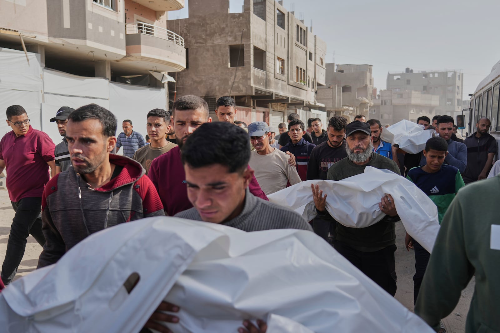 Palestinians carry the bodies of those who were killed in an overnight Israeli airstrike, during their funeral in Khan Younis, Gaza Strip, Sunday, May 11, 2025. (AP Photo/Abdel Kareem Hana)