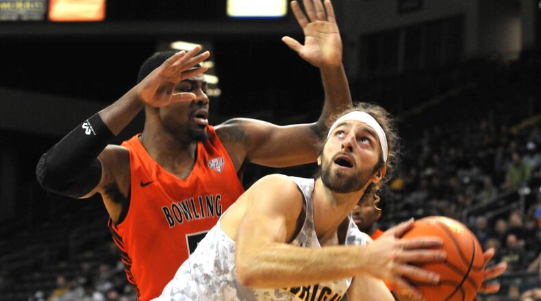 Wright State's Tim Finke, 24, prepares to take a shot against Bowling Green's Rashaun Agee, 5, during the first half of a non-conference game at the Nutter Center on Tuesday, Nov. 15. DAVID A. MOODIE/CONTRIBUTING PHOTOGRAPHER