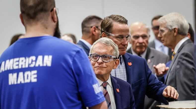 Ohio Gov. Mike DeWine shakes hands with a QQE employee Tuesday September 6, 2022 at the plant in Beavercreek. State and federal officials toured the plant that fuses quartz for the semiconductor industry. JIM NOELKER/STAFF