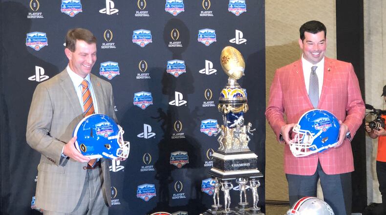 Clemson coach Dabo Swinney (left) and Ohio State coach Ryan Day pose with the Fiesta Bowl trophy one day before the Tigers and Buckeyes play.