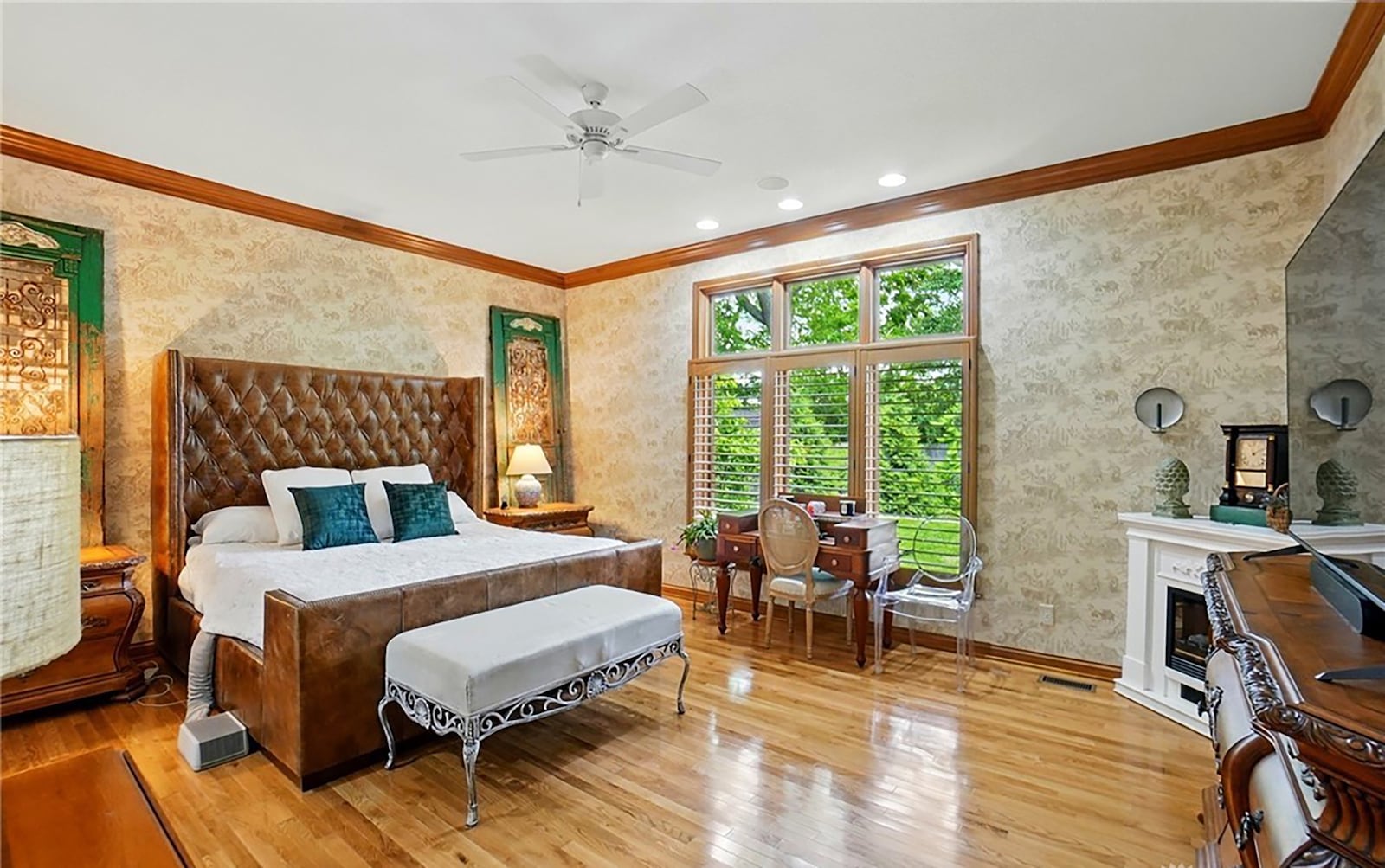 The main floor primary suite has hardwood floors, a ceiling, his and her walk in custom closets and an ensuite bathroom.