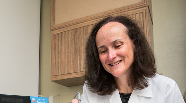 Breast surgeon Roxane Weighall, DO, demonstrates locating the radioactive seed with a gamma meter. CONTRIBUTED