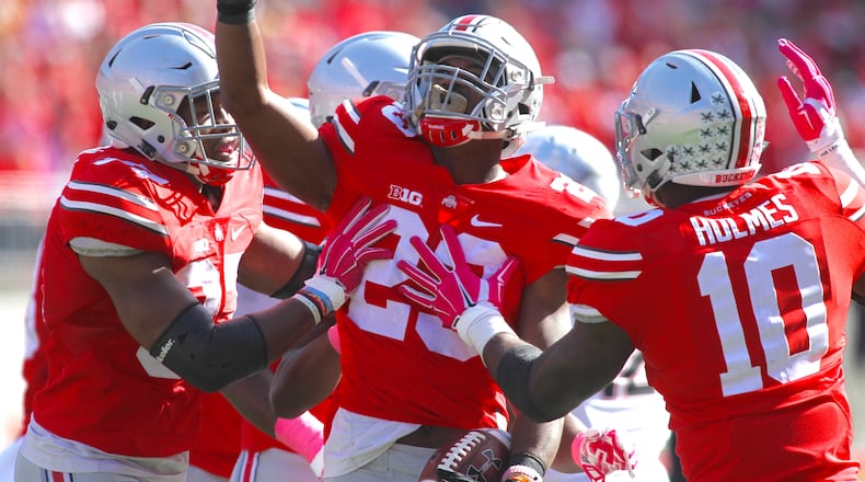 Ohio State safety Tyvis Powell, center, celebrates after an interception against Maryland on Saturday, Oct. 10, 2015, at Ohio Stadium in Columbus. David Jablonski/Staff