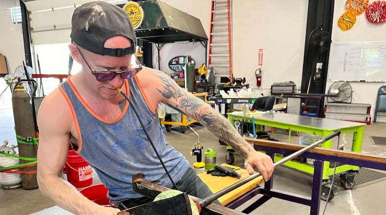Nyminal Glass, a new glass blowing studio and gallery, is open at 1900 E. Second St. in Dayton. Pictured is Owner Dustin Wagner. NATALIE JONES/STAFF