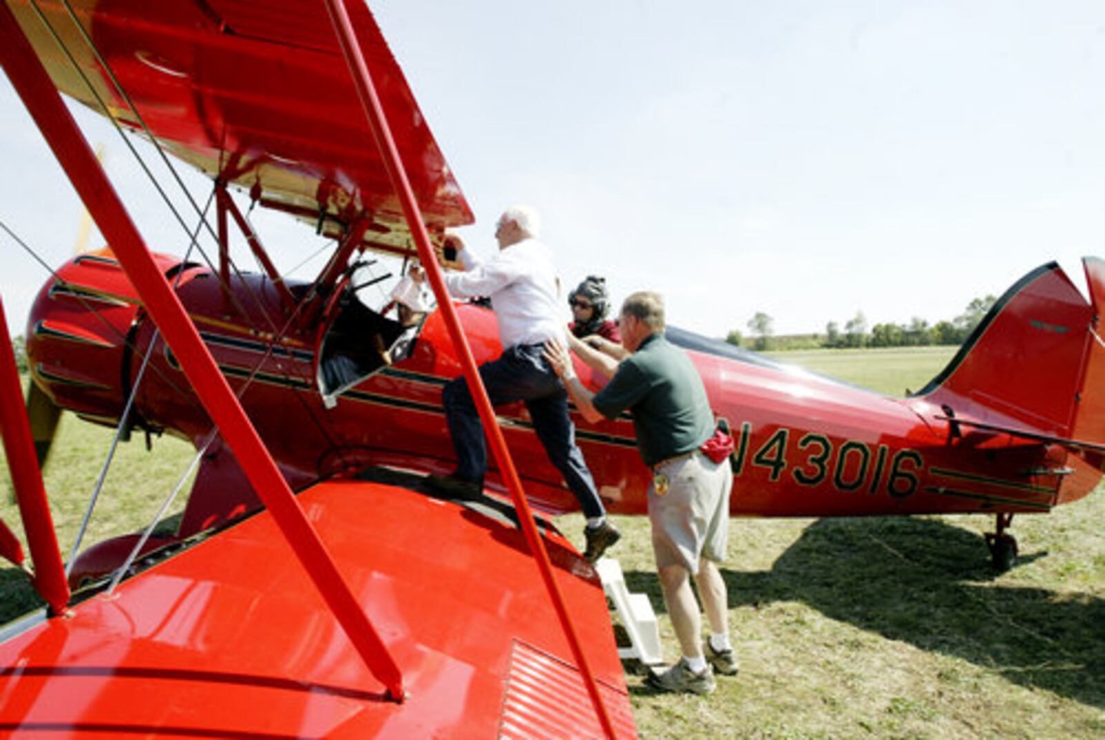 Keith Davison of Hamilton takes a WACO ride with his friend Debbie Roberts during the WACO Homecoming Fly-In in Troy on Sept. 21. The three days event is to welcome WACO planes to their "home" Troy, Ohio, where they were built until the 1940s.