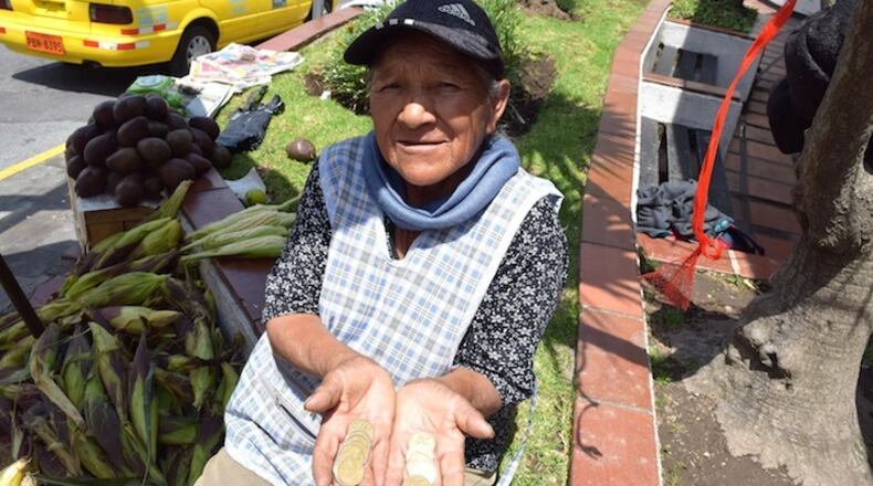 Luzmila Mita holds Sacagawea dollar coins in Quito, Ecuador. Sacagawea, an 18th Century Shoshone tribeswoman, is seen as something of a kindred spirit in Ecuador. (Jim Wyss/Miami Herald/TNS)