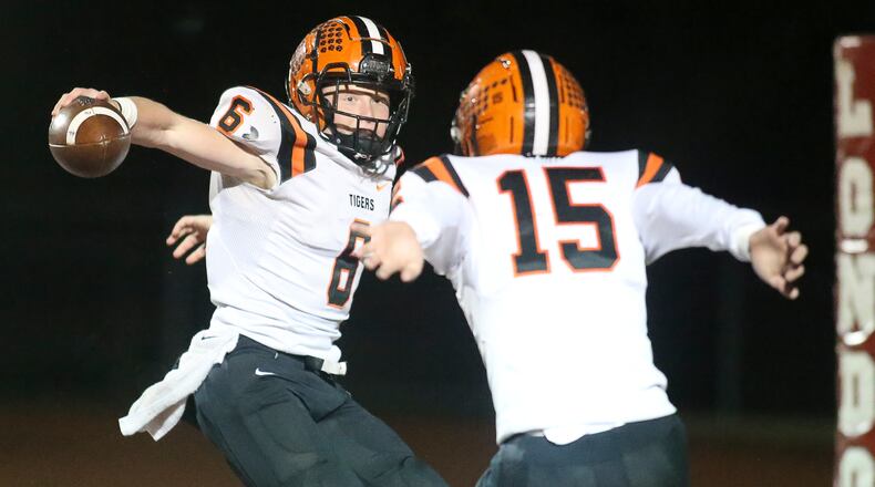 Versailles High School senior Carson Bey (left) and senior teammate Landon Henry celebrate after Bey scored a touchdown during their 28-22 victory over Canal Winchester Harvest Prep in a Division V state semifinal game on Saturday at London's Bowlus Field. Michael Cooper/CONTRIBUTED