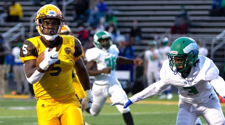 Alter running back Branden McDonald runs past Chaminade Julienne's Donaven Cummings on his way to a 28-yard touchdown on the Knights' first play from scrimmage in their 49-21 victory Thursday night at Centerville High School. Jeff Gilbert/CONTRIBUTED