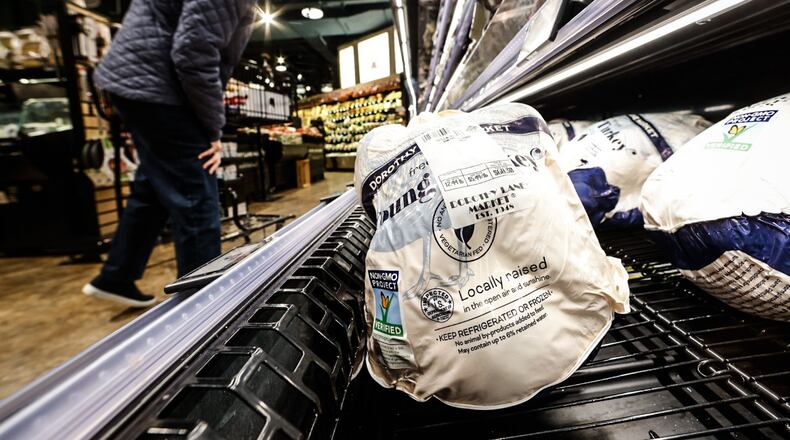 Shoppers peruse fresh turkeys at the Dorothy Lane Market in Oakwood Friday morning November 18, 2022. JIM NOELKER/STAFF
