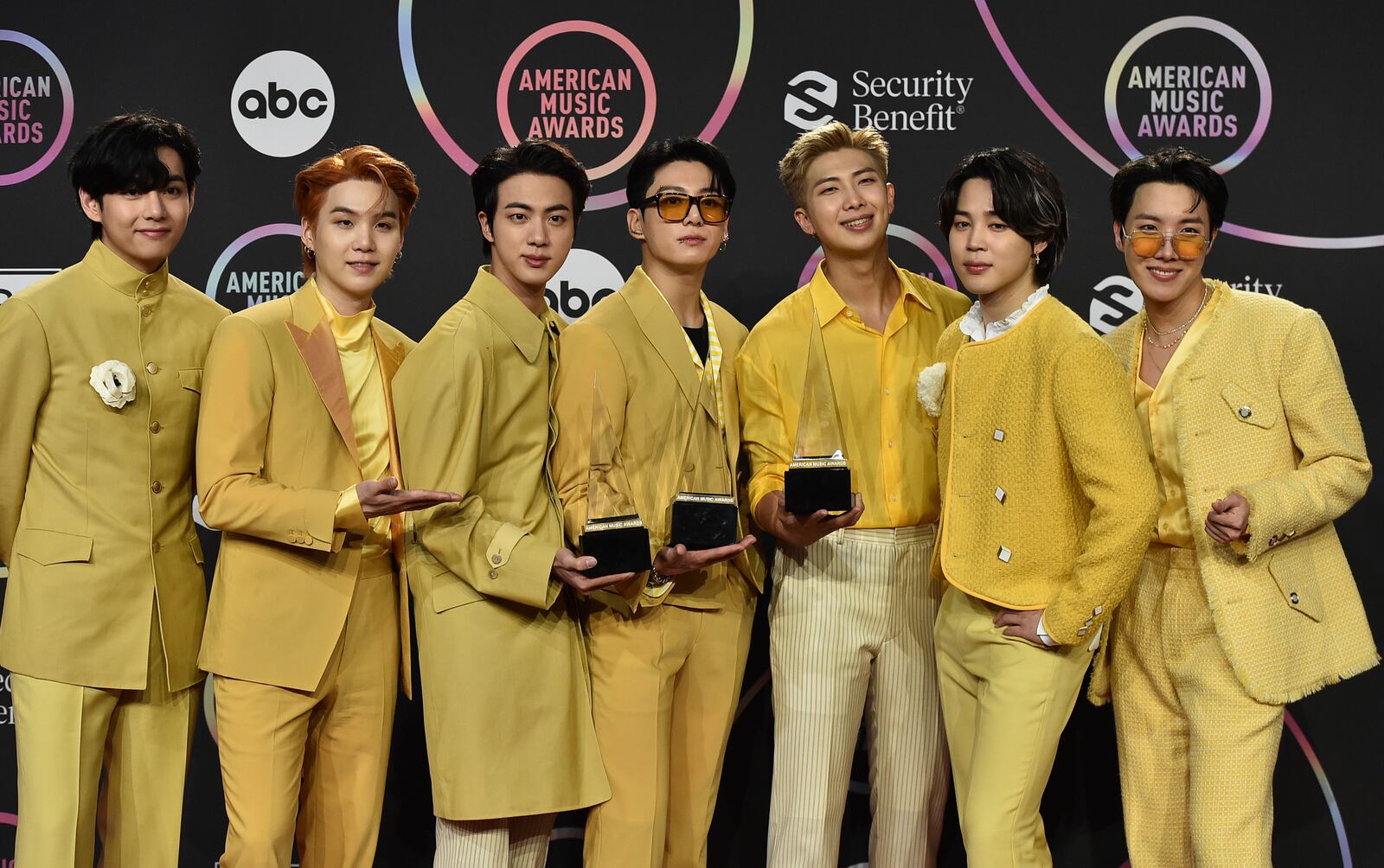 FILE - BTS poses in the press room with the awards for favorite pop duo or group, favorite pop song for "Butter," and artist of the year at the American Music Awards on Sunday, Nov. 21, 2021, at Microsoft Theater in Los Angeles. (Photo by Jordan Strauss/Invision/AP, File)
