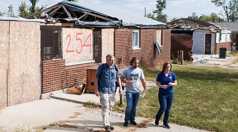 Dayton Daily News reporters Chris Stewart, left, and Josh Sweigart are retracing the path of a devastating EF4 Memorial Day tornado that cut across Montgomery County. They are seen with WHIO Chief Meteorologist McCall Vrydaghs on one leg of the journey through Brookville. CHUCK HAMLIN / STAFF