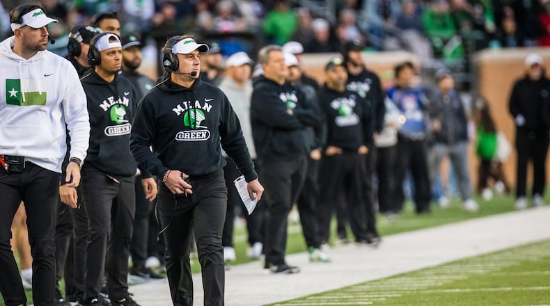 North Texas head coach Eric Morris, front right, walks the sideline during an NCAA college football game against Temple, Friday, Nov. 28, 2025, Denton, Texas. (AP Photo/Jessica Tobias)