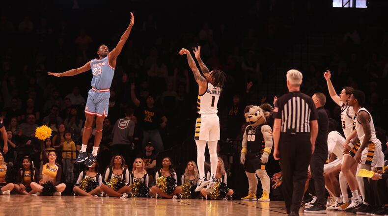 Virginia Commonwealth's Ace Baldwin makes a 3-pointer against Dayton's R.J. Blakney in the Atlantic 10 Conference championship game on Saturday, March 12, 2023, at the Barclays Center in Brooklyn, N.Y. David Jablonski/Staff