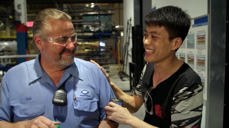 Rob Haerr and Wong He working together at the Fuyao Glass America plant in Moraine, in a photo from the film “American Factory.” CONTRIBUTED