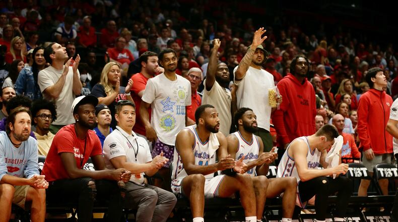 Former Flyers Ibi Watson, Jalen Crutcher and Ibi Watson watch from behind the bench during a game between the Red Scare and The Money Team on Wednesday, July 27, in the third round of The Basketball Tournament at UD Arena in Dayton. David Jablonski/Staff