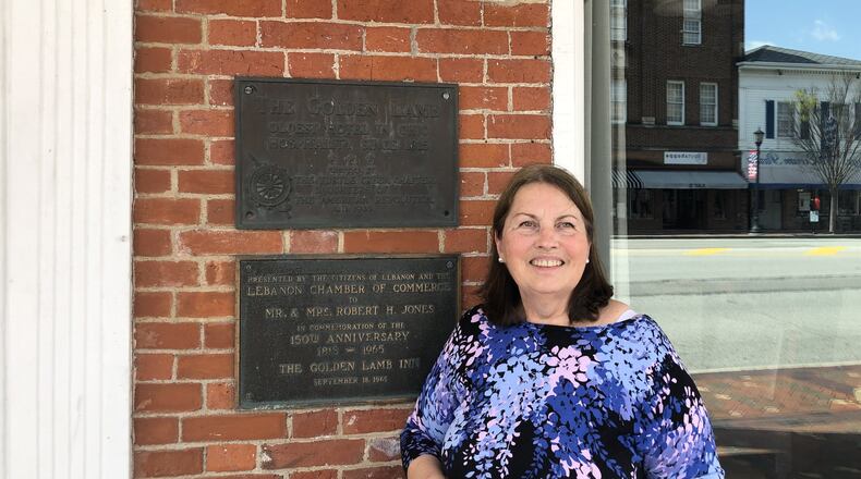Victoria Van Harlingen retired as director of the Warren Historical Society.She is standing next to the historical marker added to the front of the Golden Lamb Inn by the Daughters of the American Revolution in 1940, when the society was chartered. LAWRENCE/STAFF