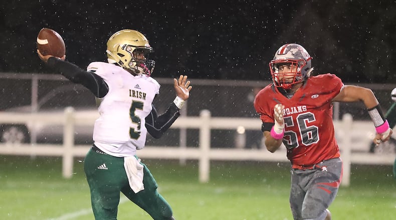 Catholic Central’s Jayden Borden throws the ball under pressure from Southeastern’s Jason Rutschilling. BILL LACKEY/STAFF