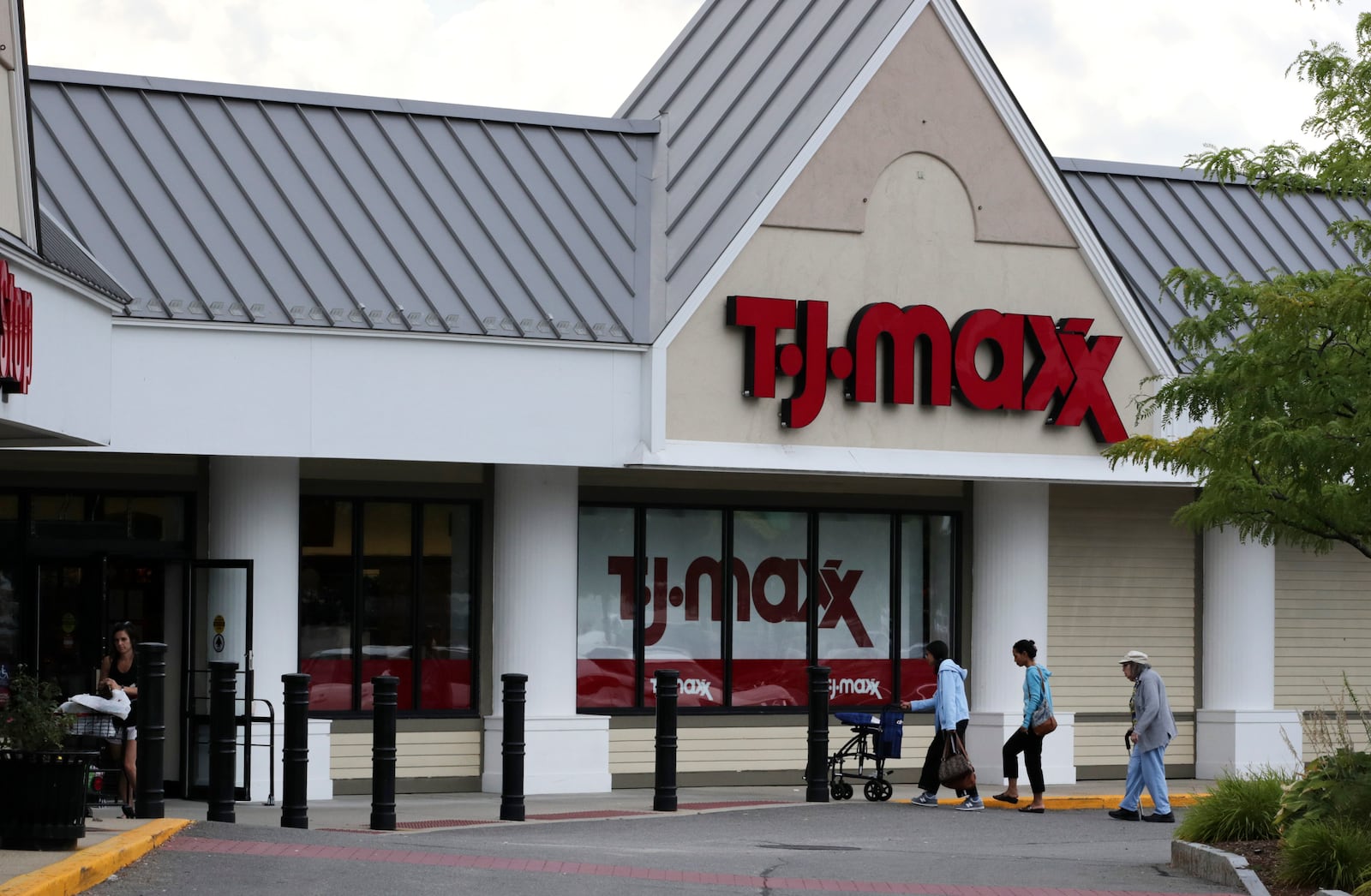 FILE - In this Aug. 15, 2019, file photo shoppers enter the TJ Maxx store in Manchester, N.H. TJX Companies Inc., parent of T.J. Maxx and other discount stores reports financial results on Wednesday, Feb. 26, 2020. (AP Photo/Charles Krupa, File)