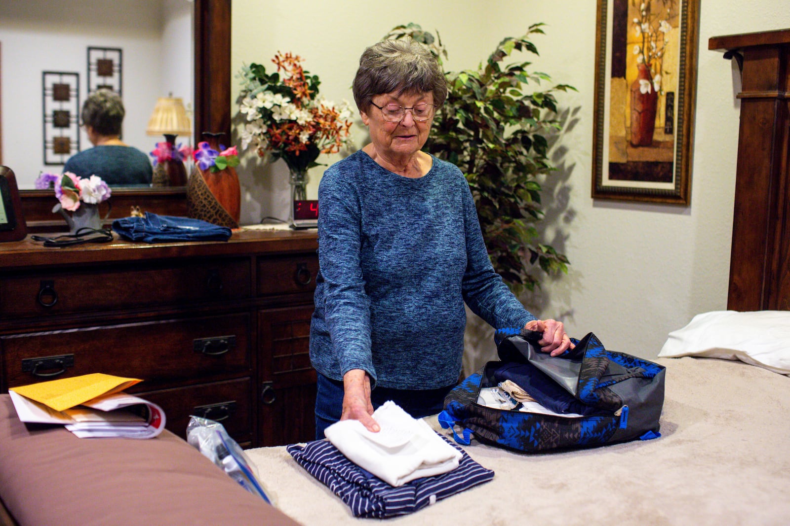 Betty Strom packs for a trip to Washington, D.C., to speak with representatives and protest carbon sequestration tax credits that incentivize carbon pipelines, at her home in Sioux Falls, S.D., on Monday, March 10, 2025. Strom was sued in condemnation by Summit Carbon Solutions and was among other South Dakota landowners who sued the company to stop them from surveying their land. (AP Photo/Nicole Neri)
