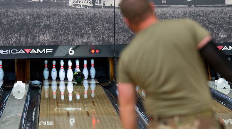 A participant watches as his shot hits the pocket during the Eagles vs. Chiefs Bowling Challenge at Wright-Patterson Air Force Base on April 9. Bowling is among numerous social activities on base that help promote the four domains of overall wellness. U.S. AIR FORCE PHOTO/WESLEY FARNSWORTH