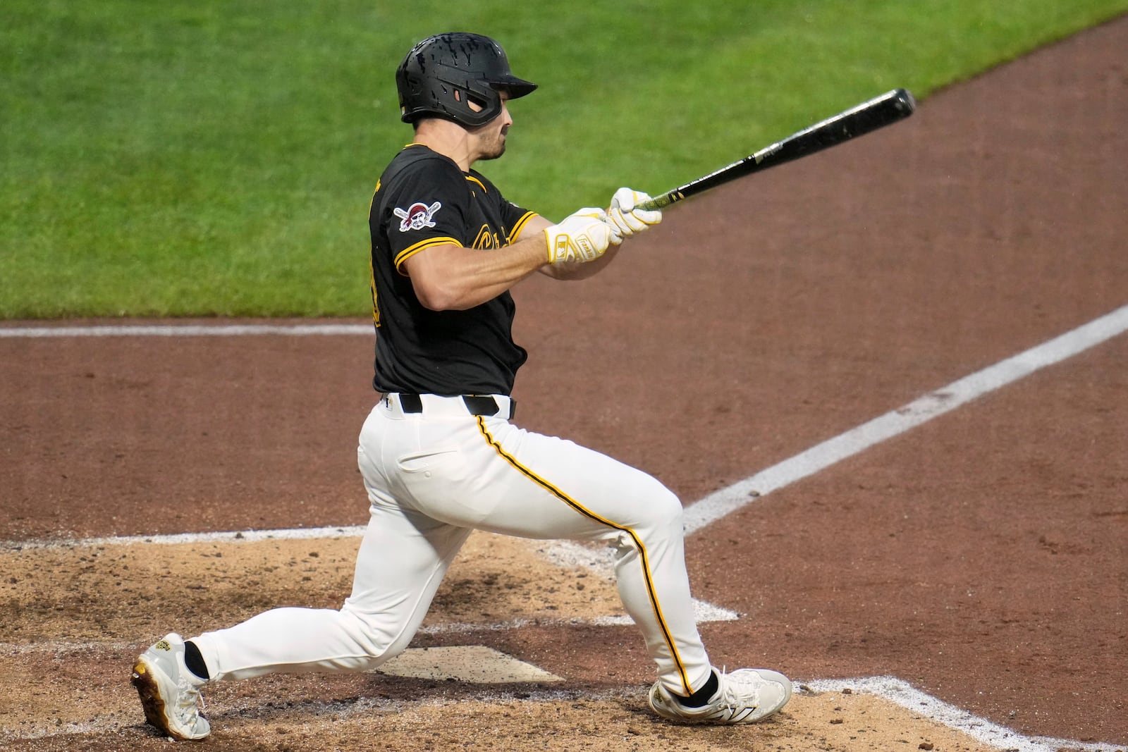 Pittsburgh Pirates' Bryan Reynolds singles off Cincinnati Reds pitcher Nick Martinez, driving in a run, during the sixth inning of a baseball game in Pittsburgh, Tuesday, May 20, 2025. (AP Photo/Gene J. Puskar)