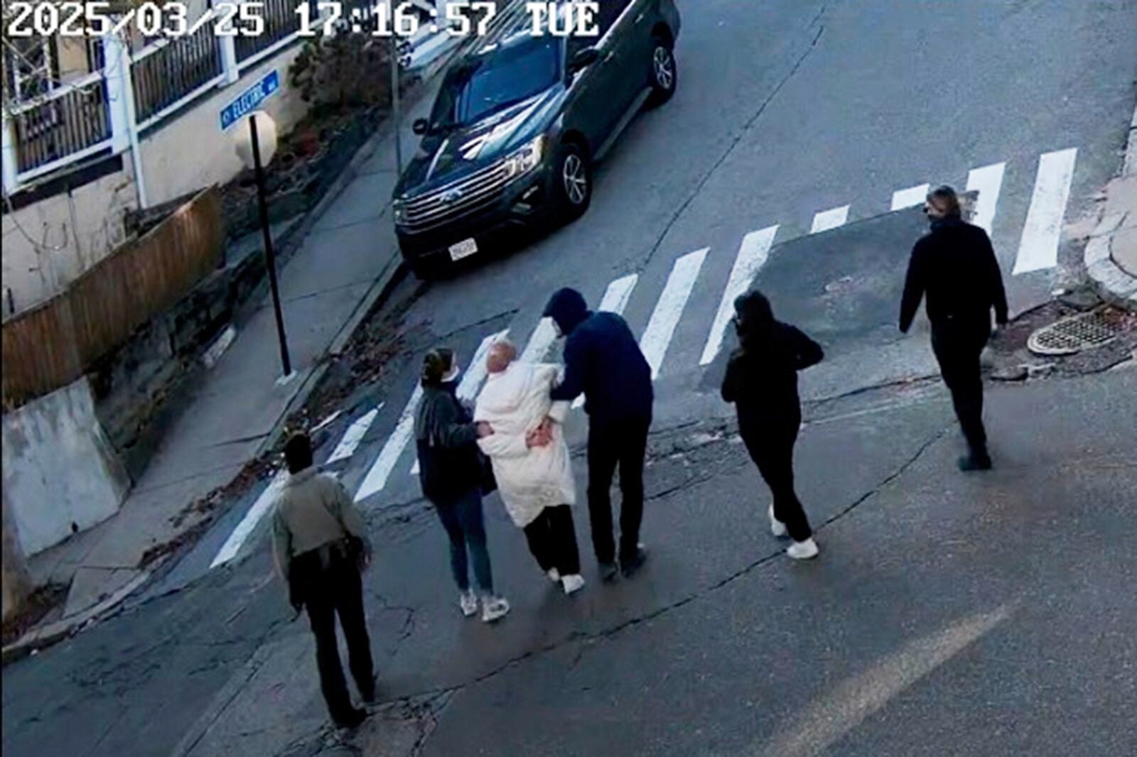 FILE - In this image taken from security camera video, Rumeysa Ozturk, a 30-year-old doctoral student at Tufts University, is detained by Department of Homeland Security agents on a street in Sommerville, Mass., March 25, 2025. (AP Photo)