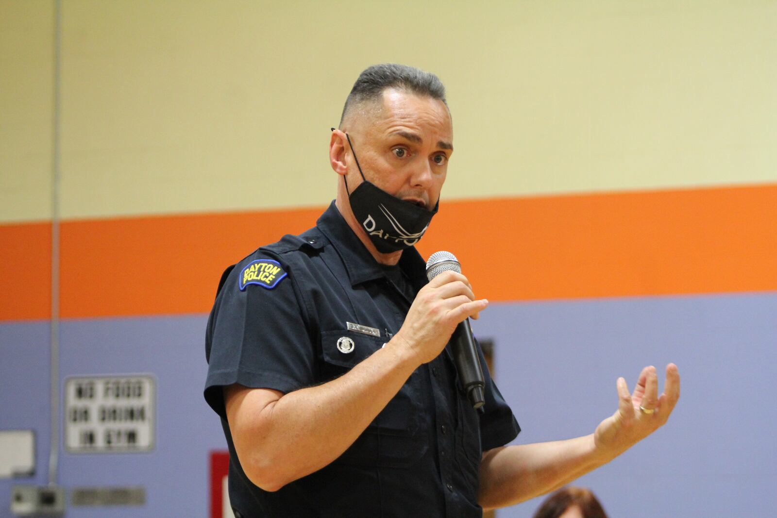 Dan Mamula, the community engagement officer with the Dayton Police Department's West Patrol Operations Division, talks to community members about automated license plate readers and neighborhood safety plans. CORNELIUS FROLIK / STAFF