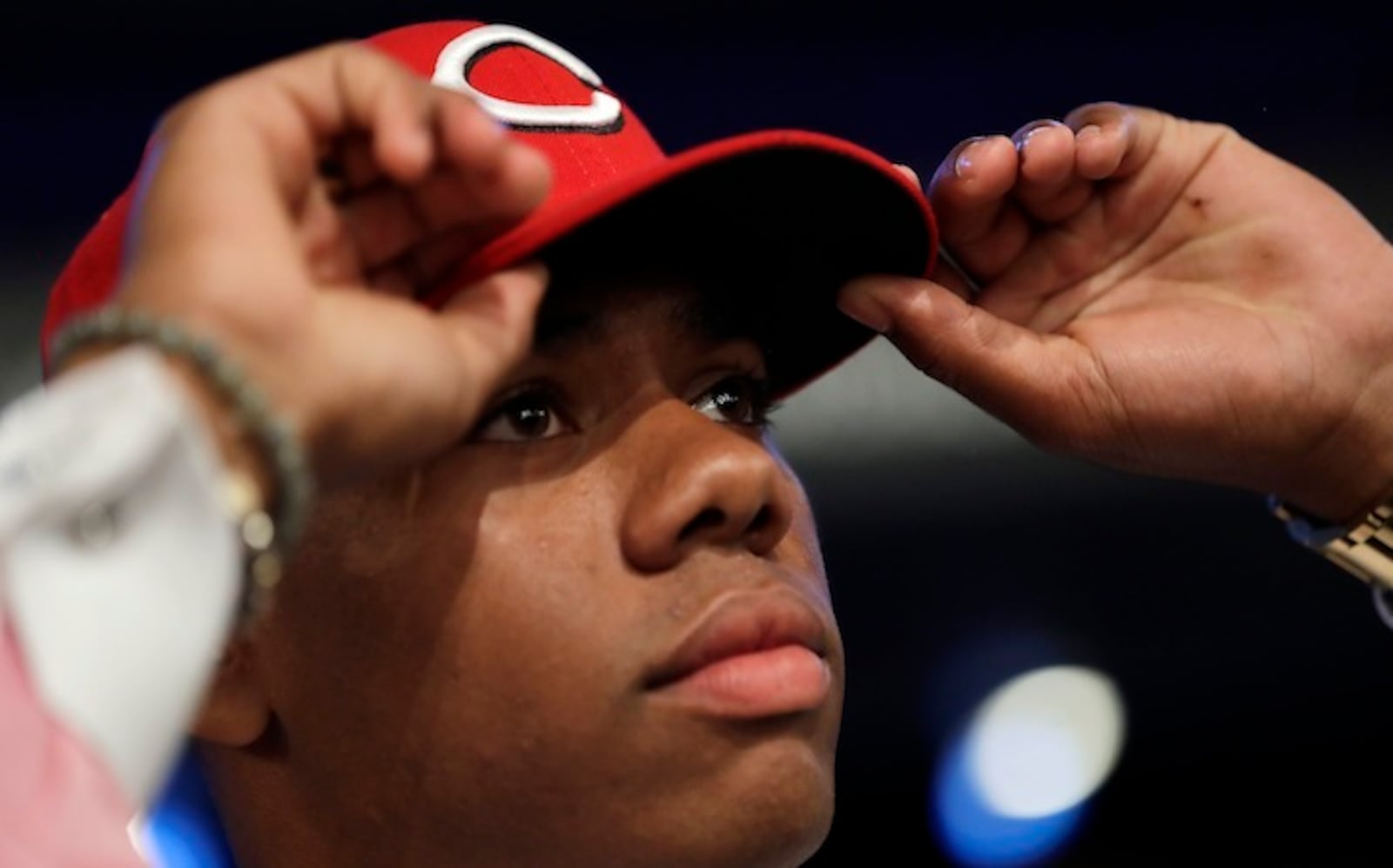 Hunter Greene, a pitcher and shortstop from Notre Dame High School in Sherman Oaks, Calif., adjusts his hat after being selected No. 2 by the Cincinnati Reds in the first round of the Major League Baseball draft, Monday, June 12, 2017, in Secaucus, N.J.(AP Photo/Julio Cortez)