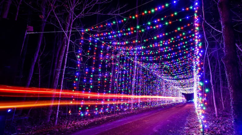 The Land of Illusion Christmas Glow on Thomas Road in Madison Township is open nightly through December with over 3.5 million lights in a 1.5 mile drive-through light display. This is one of several light tunnels on the path. NICK GRAHAM/STAFF