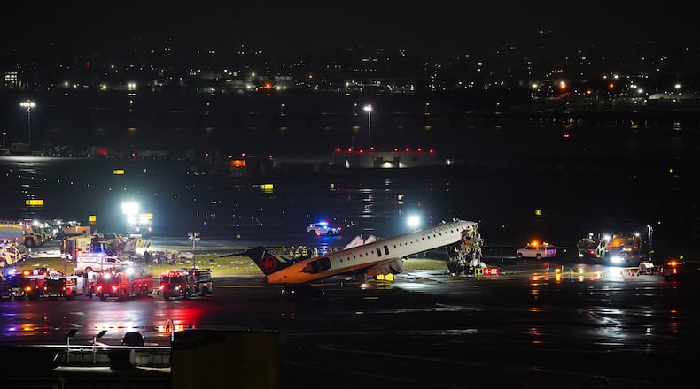 An Air Canada Jet sits on the runway at LaGuardia Airport, Monday, March 23, 2026, after colliding with a Port Authority aircraft rescue and firefighting vehicle in New York. (AP Photo/Ryan Murphy)
