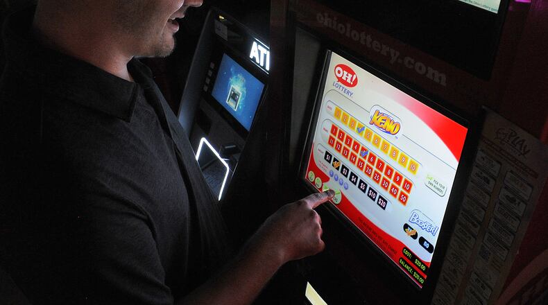 Matthew L. Adair plays a KENO game on Thursday Aug. 18, 2022 at Romer's Bar & Grill in Bellbrook. Starting in January, Ohioans will be able to place sports bets at kiosks similar to this one, at state-approved locations. Romer's is among 86 pre-approved sites in the Dayton area. MARSHALL GORBY\STAFF