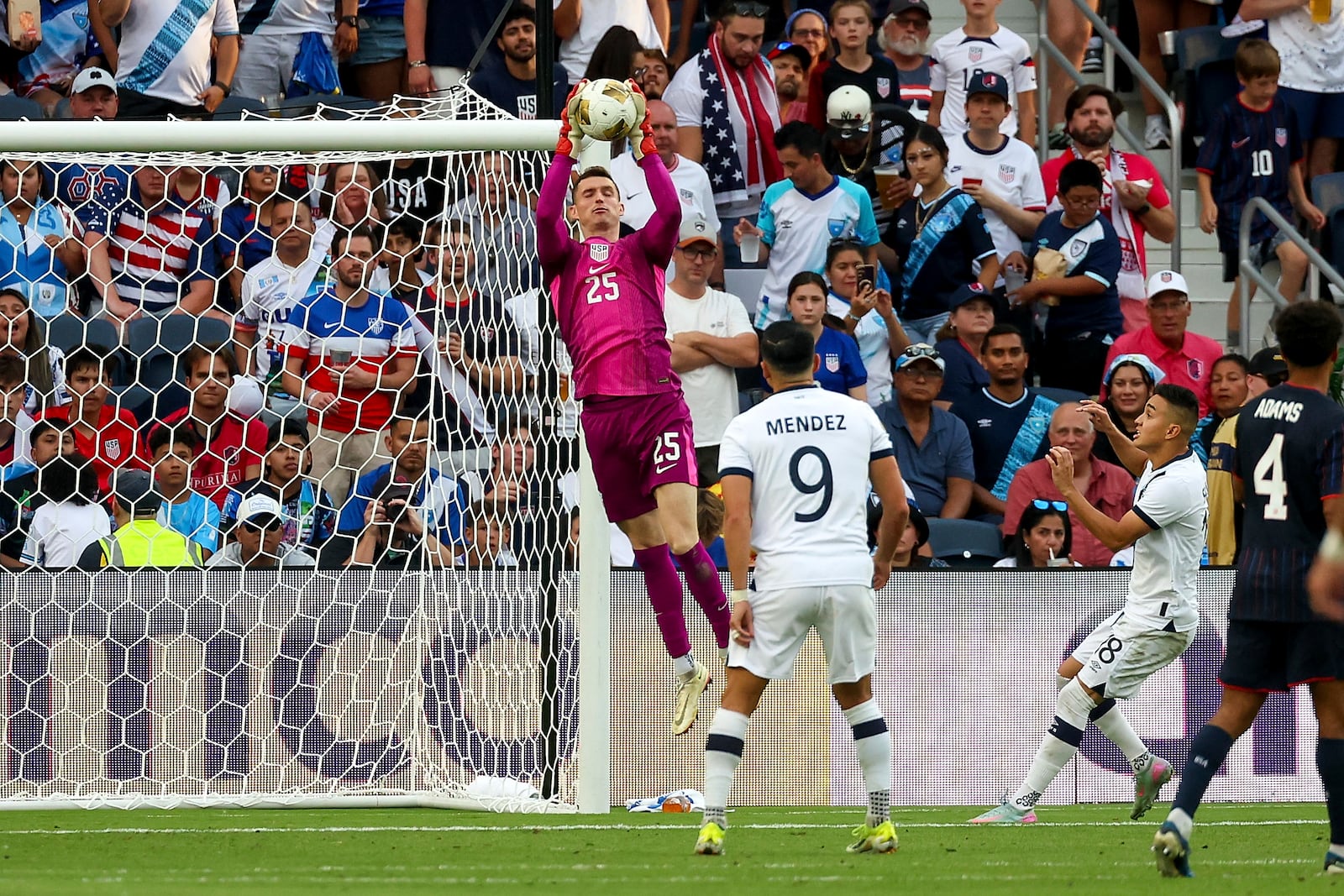 United States goalkeeper Matthew Freese (25) makes a save while Guatemala forward Rubio Mendez (9) and Oscar Santis (18) watch during the second half of a CONCACAF Gold Cup semifinal soccer match, Wednesday, July 2, 2025, in St. Louis. (AP Photo/Scott Kane)