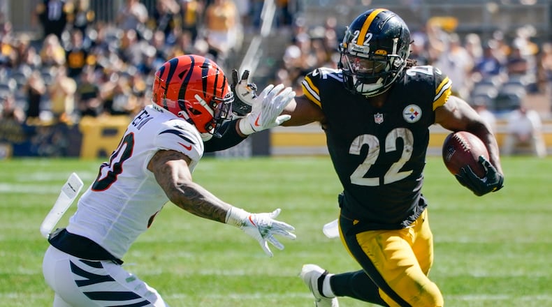 Pittsburgh Steelers running back Najee Harris (22) tries to break away from Cincinnati Bengals free safety Jessie Bates (30) during the first half an NFL football game, Sunday, Sept. 26, 2021, in Pittsburgh. (AP Photo/Gene J. Puskar)