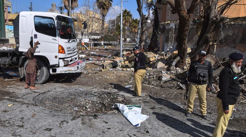 Police officers examine the site of Saturday's suicide bombing, in Quetta, Pakistan, Sunday, Feb. 1, 2026. (AP Photo/Arshad Butt)