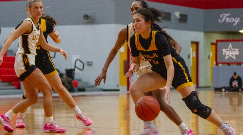 Centerville point guard Kaitlyn Palomino drives past Sidney's Kellis McNeal during Wednesday night's Division I tournament game at Troy High School. Jeff Gilbert/CONTRIBUTED