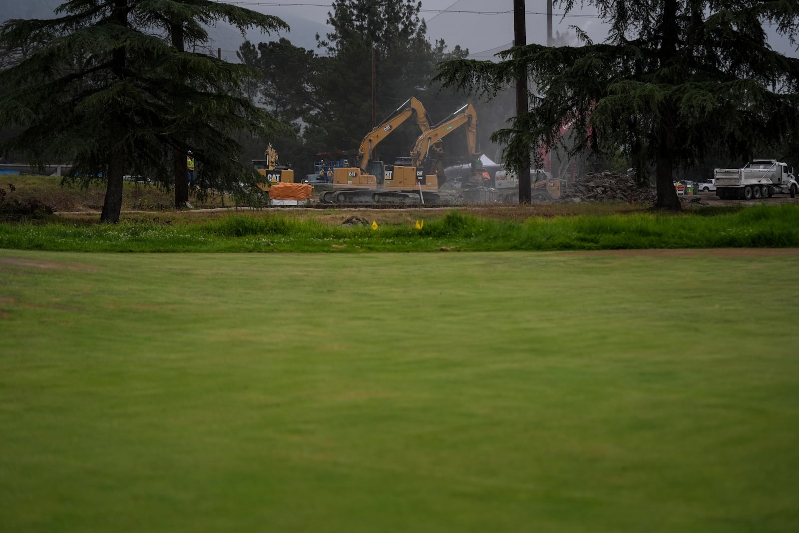 Debris from January wildfires is processed at a recycling facility set up on a golf course in Altadena, Calif., Wednesday, June 4, 2025. (AP Photo/Jae C. Hong)