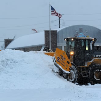 The Airway Shopping Center has large equipment, moving snow into piles in their parking lot Friday, Jan 19, 2024 to make way for customers to park. MARSHALL GORBY\STAFF