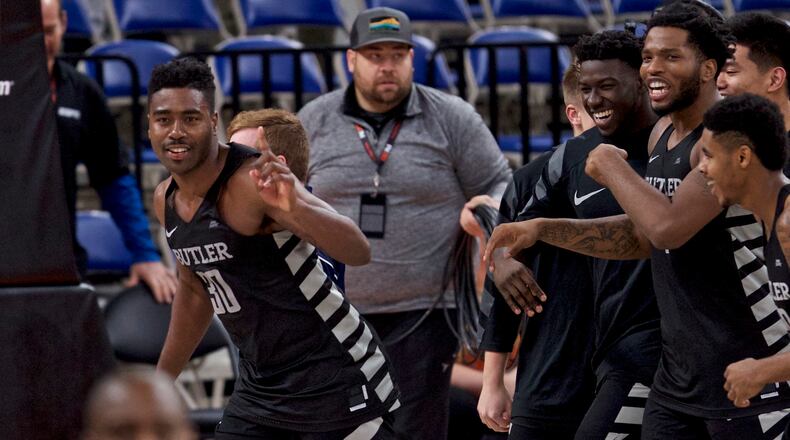 Butler forward Kelan Martin, left, reacts after making the game winning basket during overtime of an NCAA college basketball game against Ohio State in the Phil Knight Invitational tournament in Portland, Ore., Sunday, Nov. 26, 2017. (AP Photo/Craig Mitchelldyer)