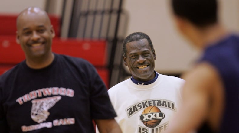 Ike thornton Sr. (center) watches as his son, Ike Thornton Jr. (left), conducts a Trotwood Madison basketball practice in March, 2006. STAFF FILE PHOTO