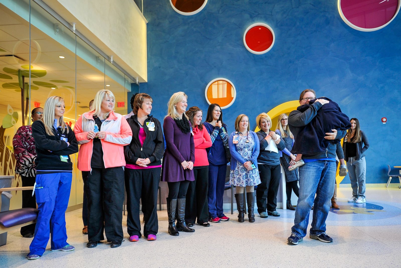 Ella Phillips-Shimovetz, 4, of Beavercreek, held by her mother Cheryl Shimovetz, is greeted by staff of the Proton Therapy Center after she was surprised by her family with a horse-drawn carriage ride by Karen’s Carriage to take her to her final radiation treatment at the Cincinnati Children’s Liberty Campus Wednesday morning, Nov. 16 in Liberty Township. She is one of the first pediatric patients to complete treatment at the Cincinnati Children’s/UC Health Proton Therapy Center. In May, doctors diagnosed Ella with a cancerous tumor, Rhabdomyosarcoma of the biliary tract. After her carriage ride, Ella will undergo her final 28th radiation treatment. NICK GRAHAM/STAFF