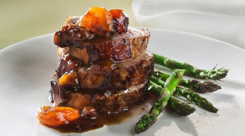 Pork tenderloin with apricot and prune sauce needs a wine to bring the zesty and sweet elements together. (Bill Hogan/Chicago Tribune/TNS)