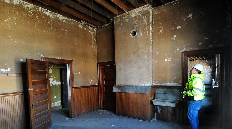Ben Sutherly gives a tour Wednesday, Feb. 14, 2024 inside the controversial Troy Tavern/IOOF building, which the Troy Historic Preservation Alliance is trying to save. MARSHALL GORBY\STAFF